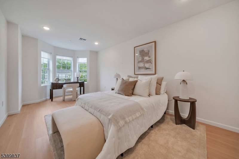 70 Ridgedale Avenue, Unit 102 Morristown, NJ 07960 - Photo 6 of 18 a bedroom with bed and a large window