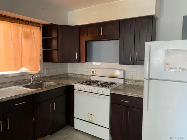 a kitchen with a sink and a refrigerator
