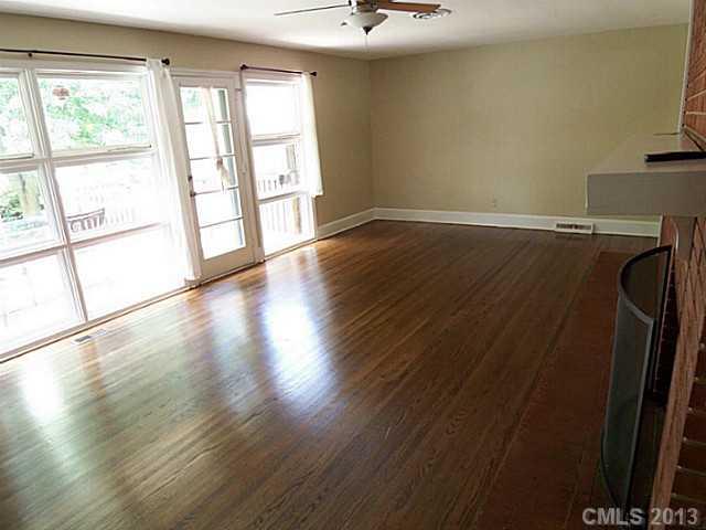 1943 Townsend Avenue Charlotte, NC 28205 - Photo 2 of 16 wooden floor in an empty room with a window