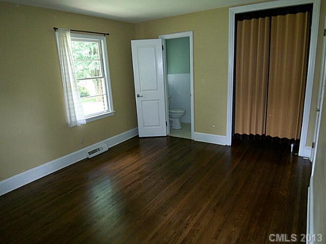 1943 Townsend Avenue Charlotte, NC 28205 - Photo 13 of 16 an empty room with wooden floor and windows