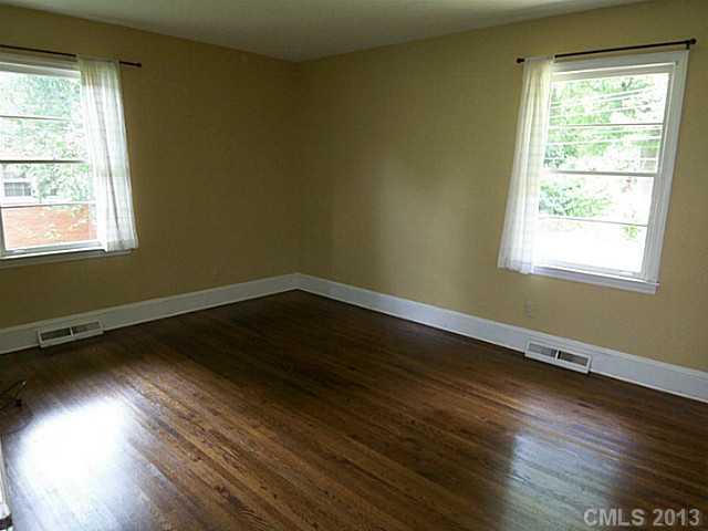 1943 Townsend Avenue Charlotte, NC 28205 - Photo 14 of 16 an empty room with wooden floor and windows