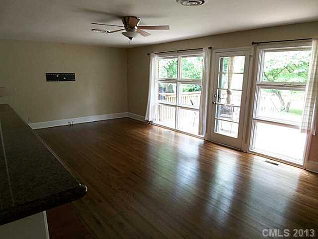 1943 Townsend Avenue Charlotte, NC 28205 - Photo 6 of 16 an empty room with wooden floor and windows