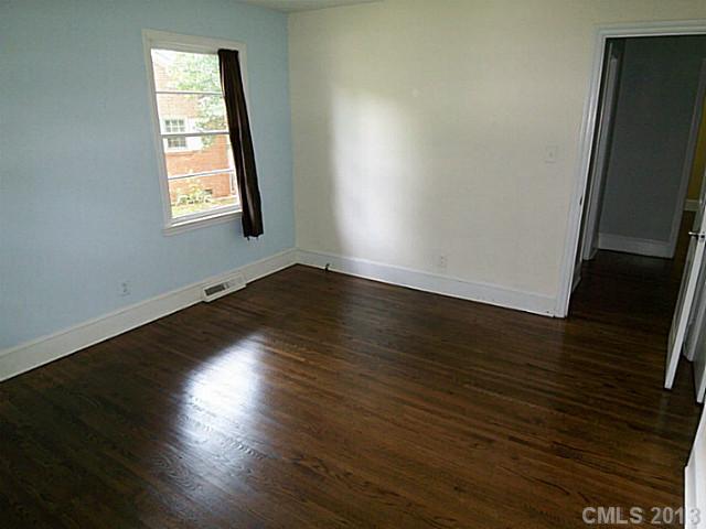 1943 Townsend Avenue Charlotte, NC 28205 - Photo 9 of 16 an empty room with wooden floor and windows