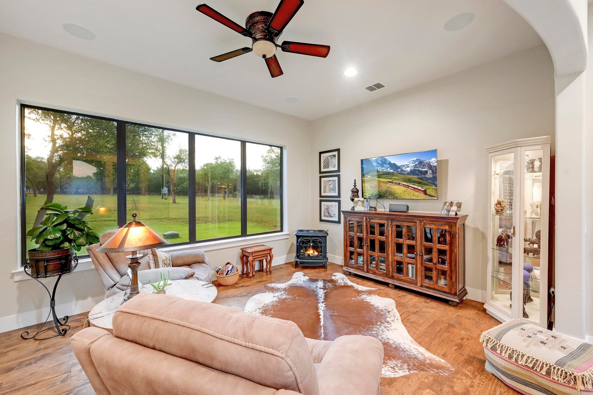 401 Trail Ridge Road Wimberley, TX 78676 - Photo 13 of 34 Living area with a wood stove, a ceiling fan, wood finished floors, and recessed lighting