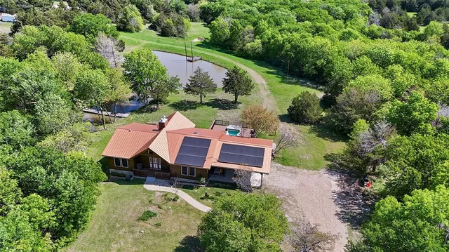 an aerial view of a house with garden space and street view