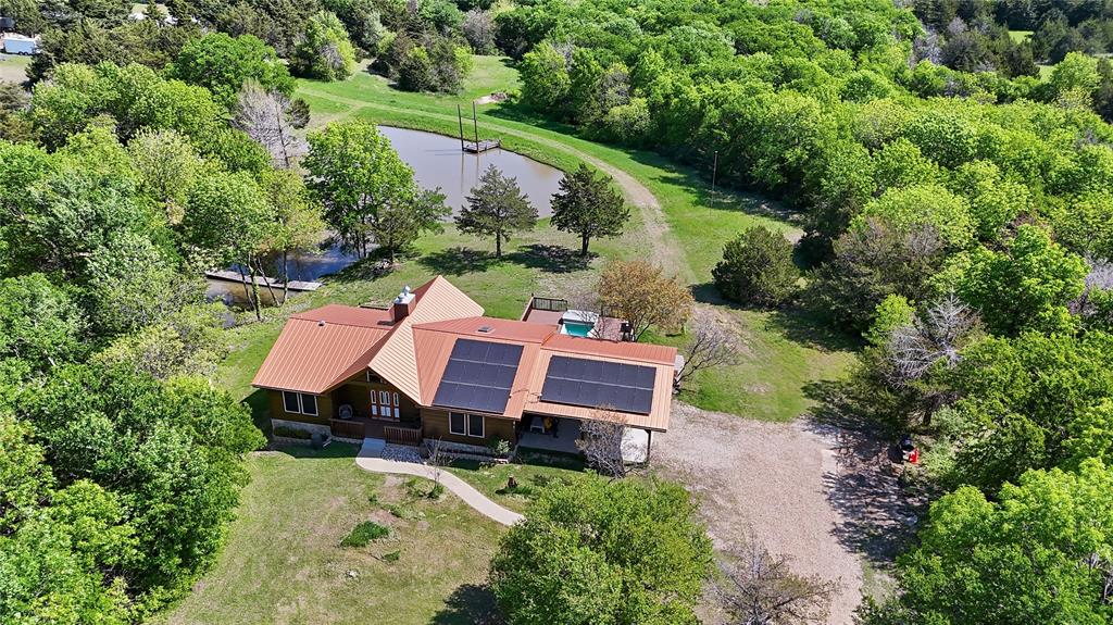 an aerial view of a house with garden space and street view