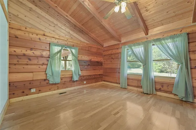 a view of an empty room with a fireplace and a window