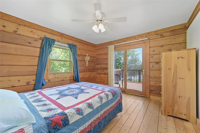 a bedroom with a bed and a large window with outer view