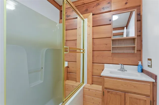 a bathroom with a shower and a sink