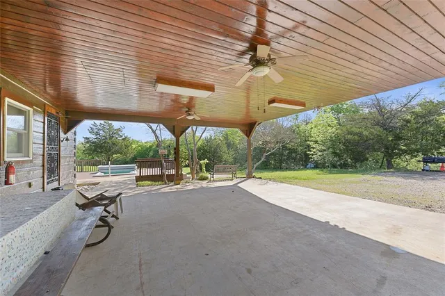 a view of a patio with a table and chairs under an umbrella