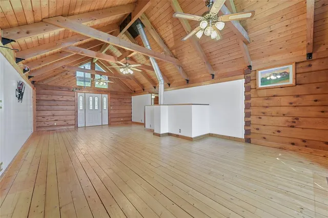 a view of a room with wooden floor