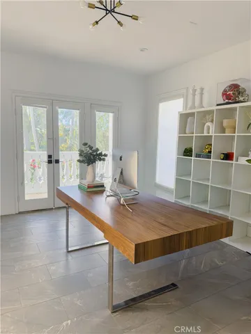 a room with pool table and windows