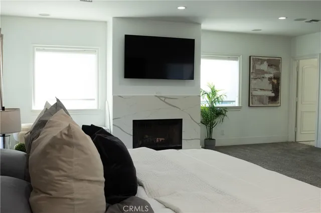a large white kitchen with a sink stainless steel appliances and cabinets