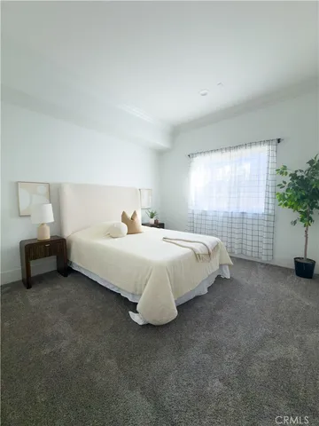 a bed sitting in a bedroom next to a window