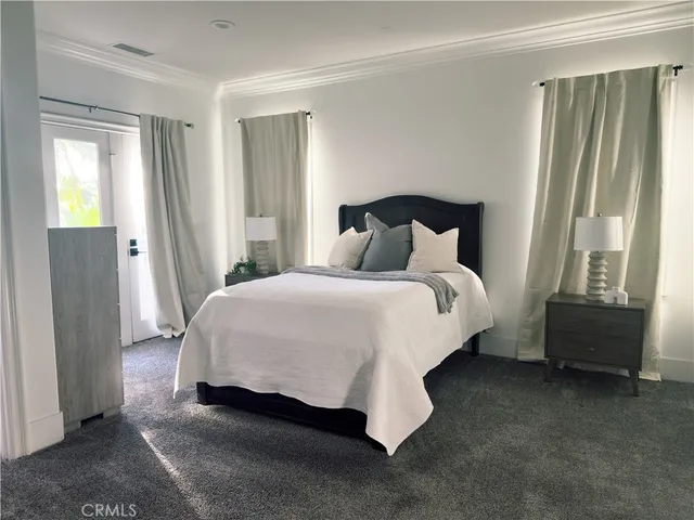 a large white kitchen with cabinets