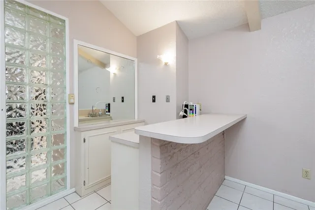 a bathroom with a sink a mirror and a shower