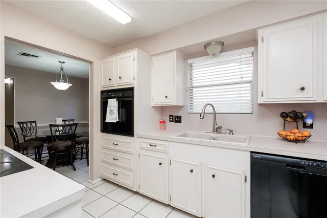 a kitchen with stainless steel appliances a sink stove and cabinets