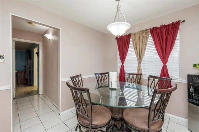 a view of a dining room with furniture and window
