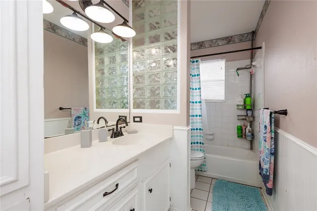 a bathroom with a sink a large mirror and a bathtub