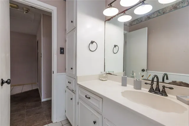 a bathroom with a double vanity sink and a mirror