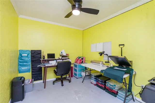 a view of a workspace with furniture and a window