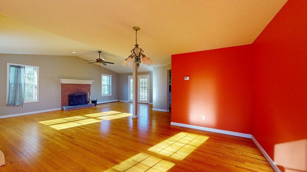 53 Dogwood Road Hubbardston, MA 01452 - Photo 15 of 42 a view of an empty room with a fireplace and wooden floor
