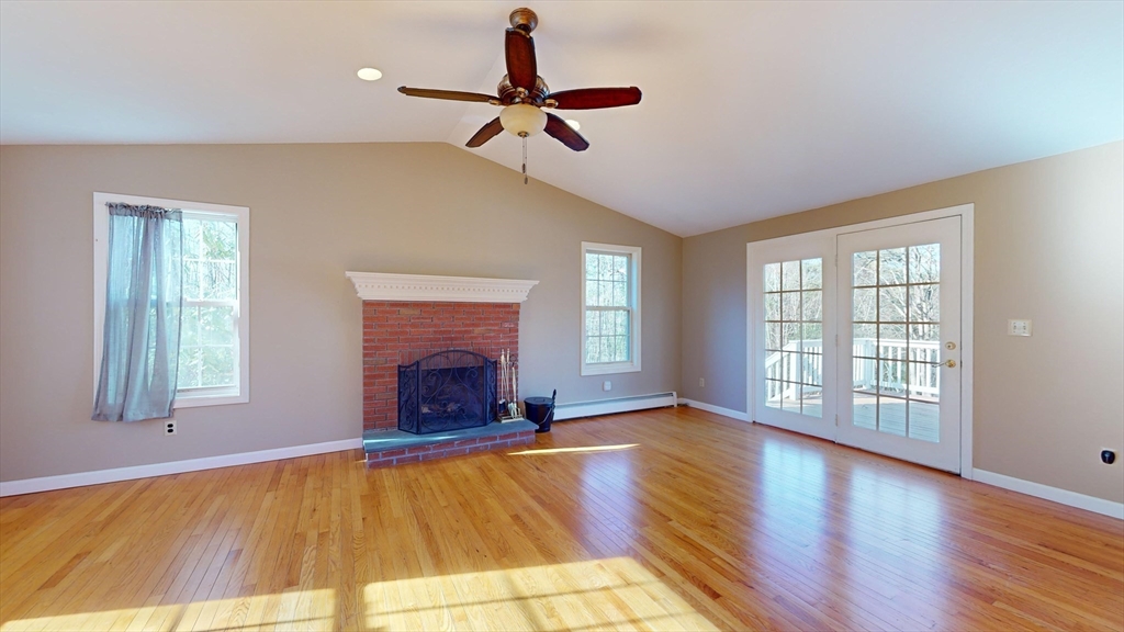 53 Dogwood Road Hubbardston, MA 01452 - Photo 17 of 42 a view of an empty room with a fireplace and a window