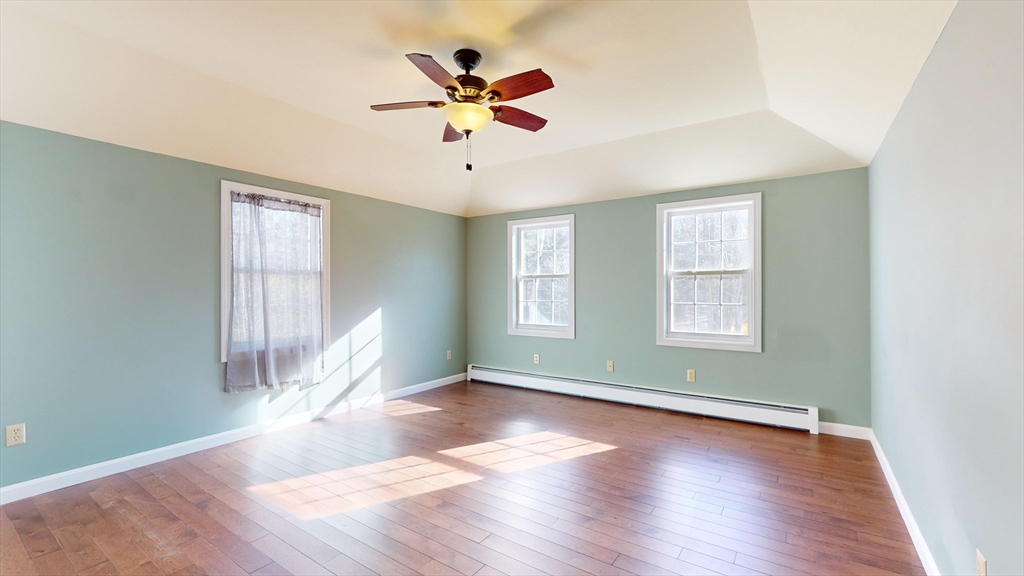 53 Dogwood Road Hubbardston, MA 01452 - Photo 26 of 42 an empty room with wooden floor fan and windows