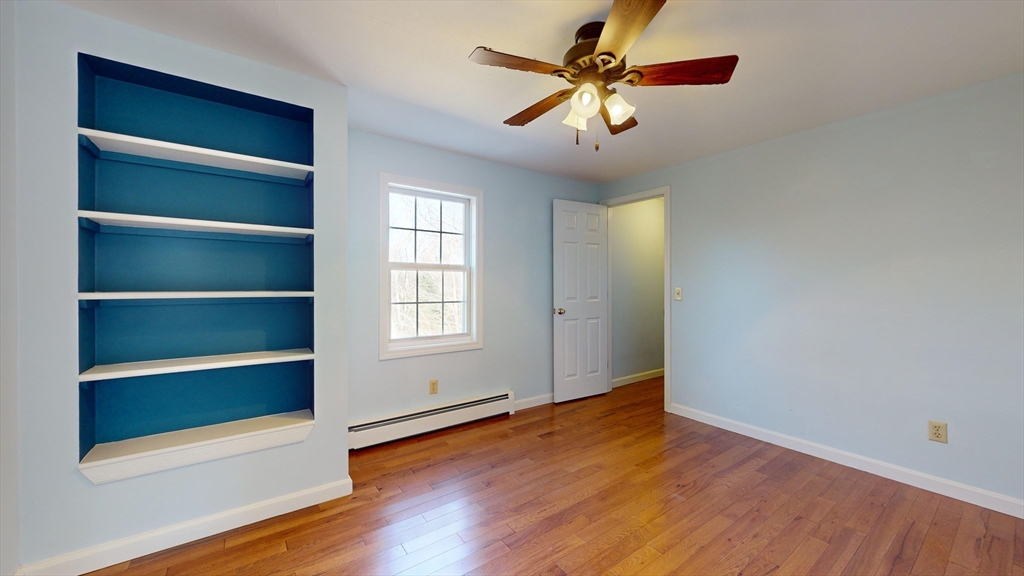 53 Dogwood Road Hubbardston, MA 01452 - Photo 31 of 42 a view of an empty room with a window and wooden floor