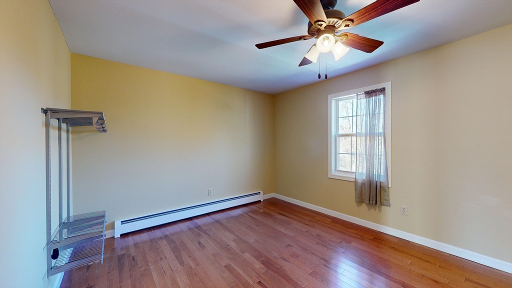 53 Dogwood Road Hubbardston, MA 01452 - Photo 36 of 42 a view of empty room with wooden floor and fan