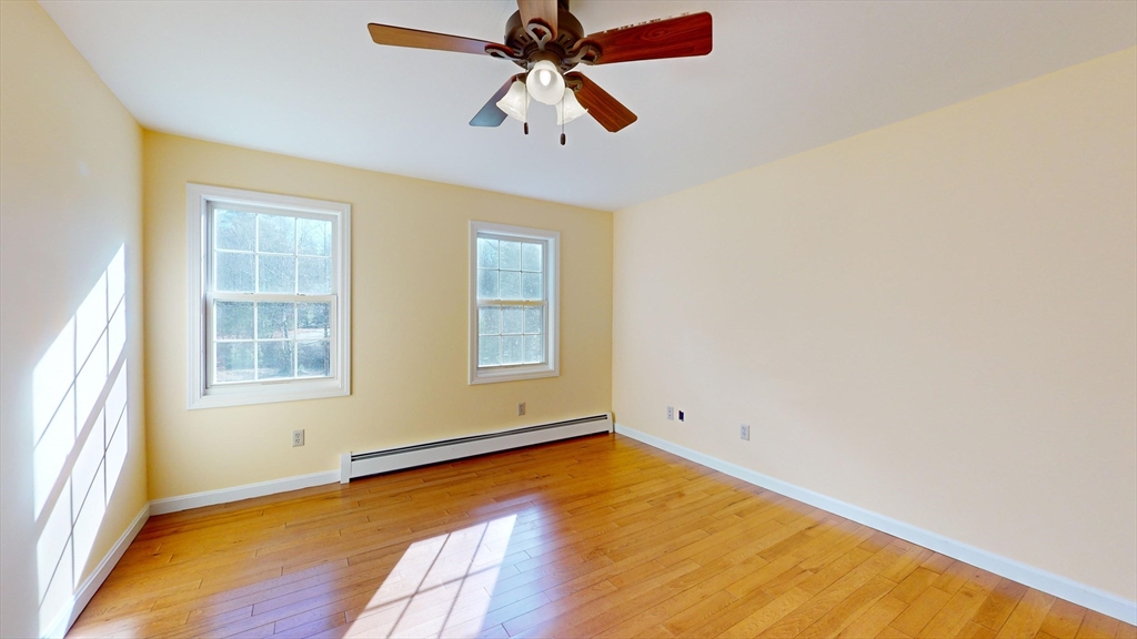 53 Dogwood Road Hubbardston, MA 01452 - Photo 39 of 42 an empty room with chandelier fan and windows