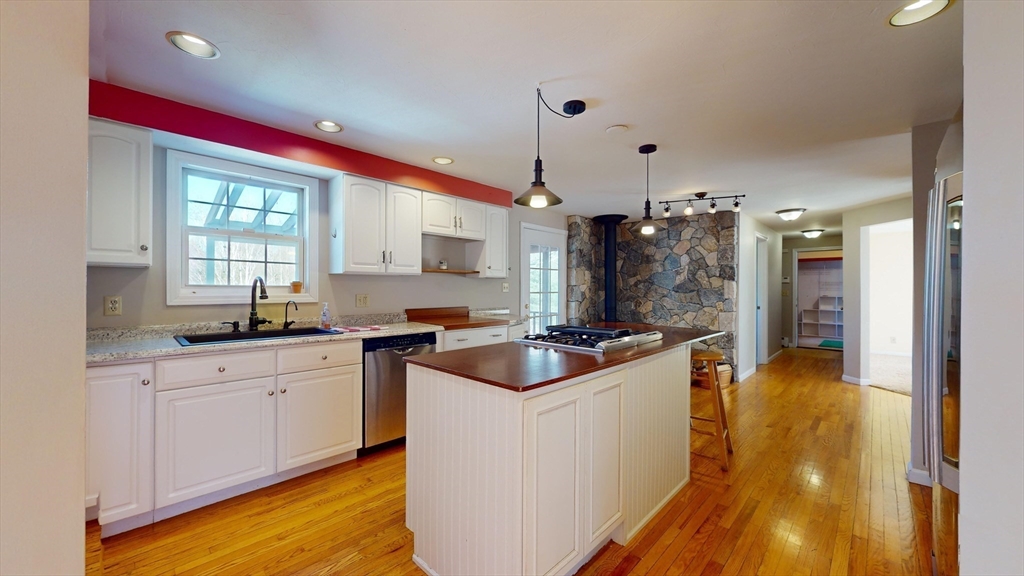 53 Dogwood Road Hubbardston, MA 01452 - Photo 10 of 42 a kitchen with kitchen island a sink a counter top space and stainless steel appliances