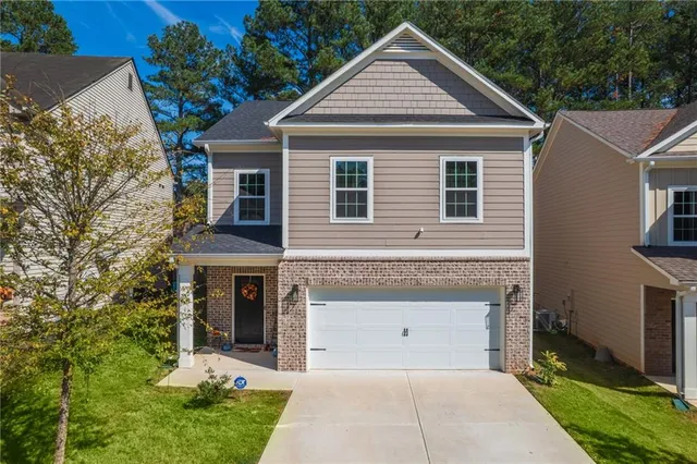 a front view of a house with a yard