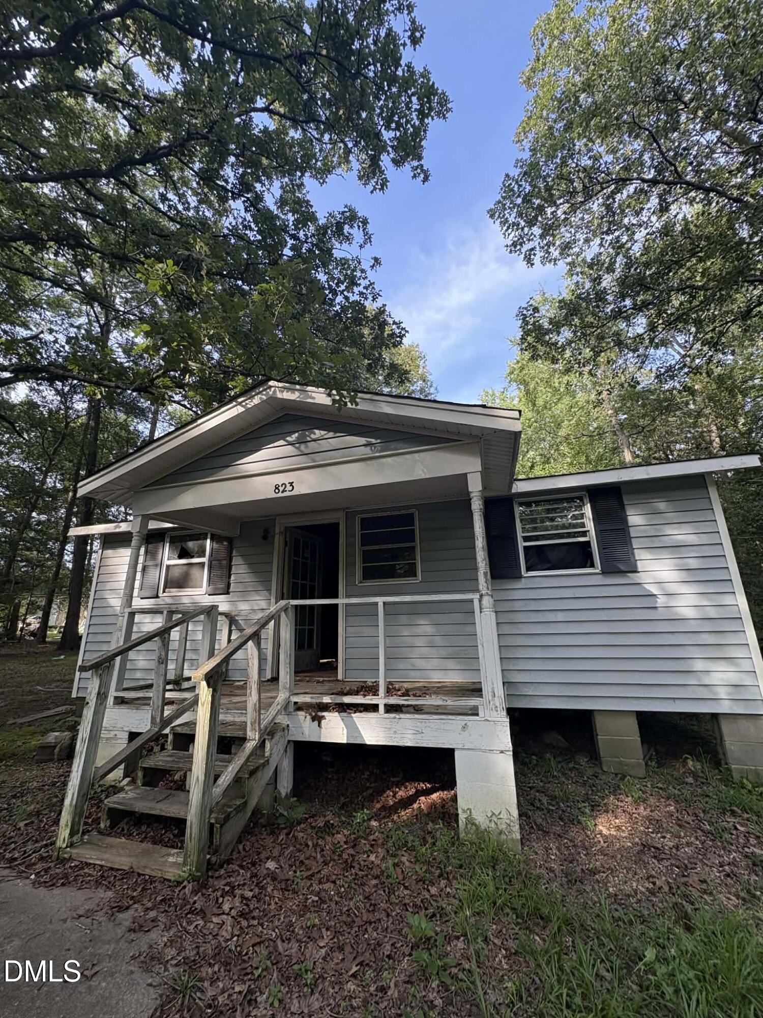 a front view of a house with plants