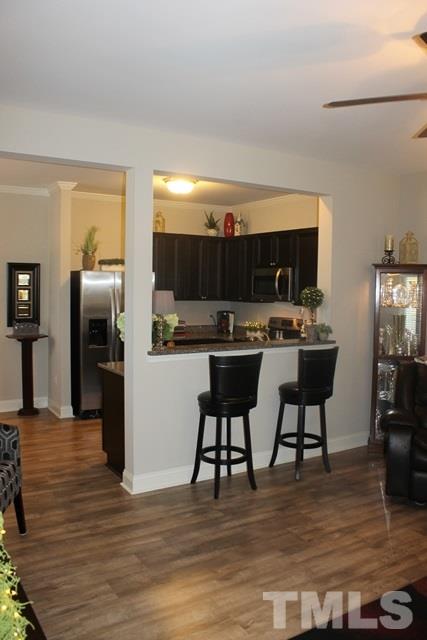 3972 Volkswalk Place Raleigh, NC 27610 - Photo 14 of 24 a living room with stainless steel appliances furniture and a kitchen view
