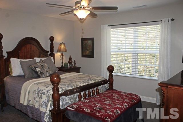 3972 Volkswalk Place Raleigh, NC 27610 - Photo 21 of 24 a bedroom with a bed and a window