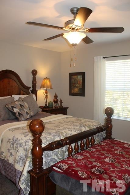3972 Volkswalk Place Raleigh, NC 27610 - Photo 22 of 24 a bedroom with a bed and window