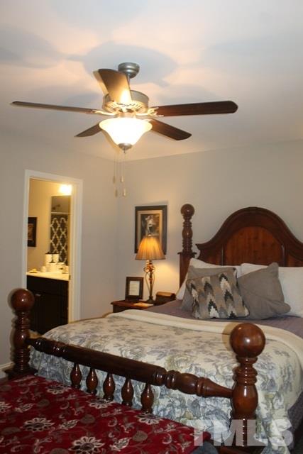 3972 Volkswalk Place Raleigh, NC 27610 - Photo 23 of 24 a bedroom with furniture and a chandelier