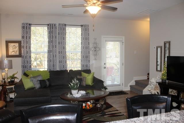 3972 Volkswalk Place Raleigh, NC 27610 - Photo 6 of 24 a living room with furniture and a flat screen tv