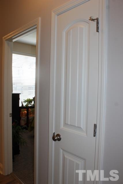 3972 Volkswalk Place Raleigh, NC 27610 - Photo 8 of 24 a bathroom with a glass shower door