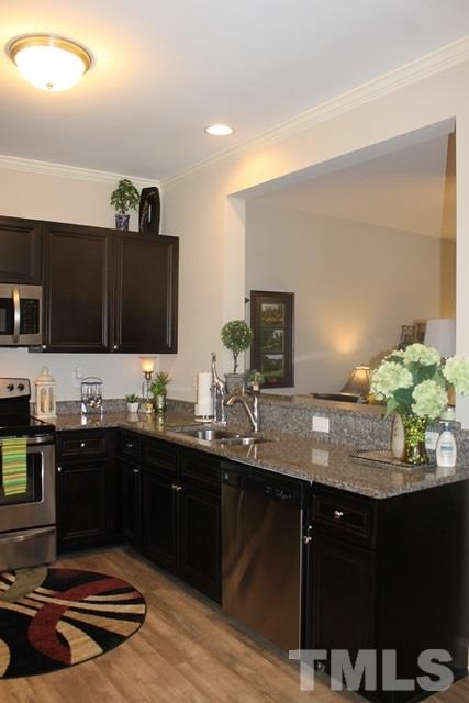 3972 Volkswalk Place Raleigh, NC 27610 - Photo 10 of 24 a kitchen with a sink and cabinets