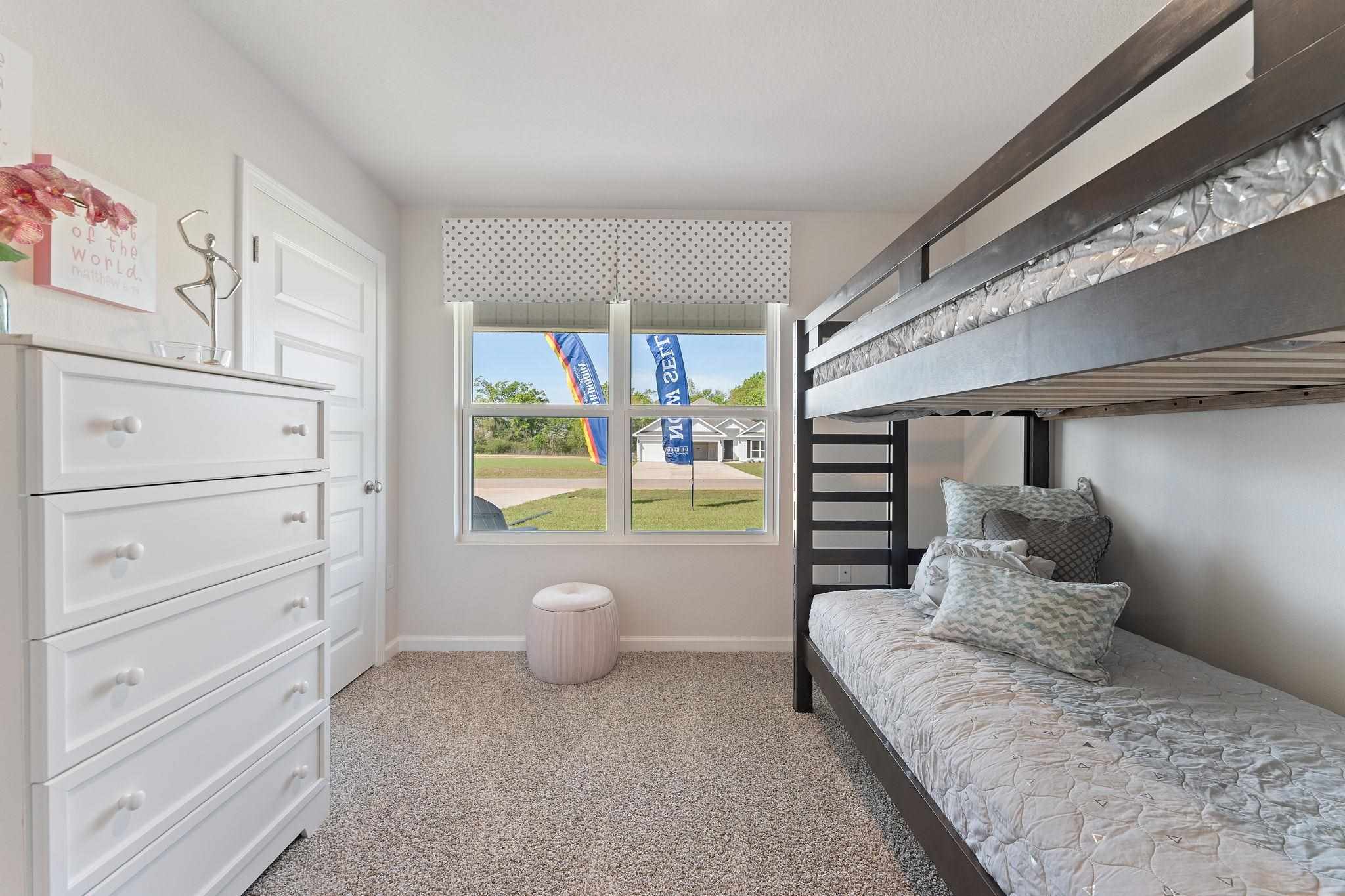 7505 Saddlebrook Avenue Pace, FL 32571 - Photo 4 of 16 a spacious bedroom with a bed and a window