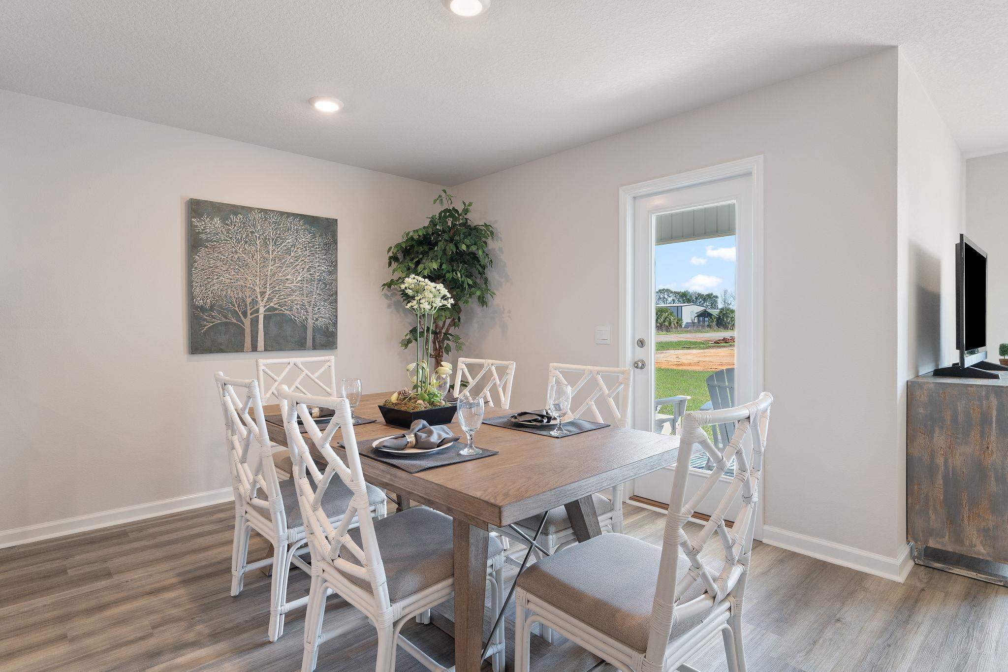 7505 Saddlebrook Avenue Pace, FL 32571 - Photo 10 of 16 a view of a dining room with furniture and wooden floor