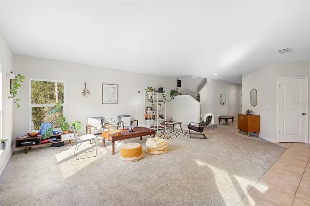 a kitchen with granite countertop a refrigerator and a stove top oven