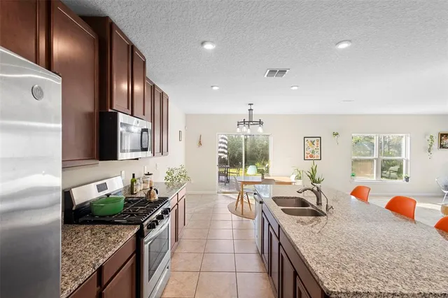 a bathroom with a sink double vanity granite tub and a mirror