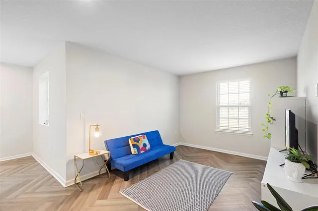 a bedroom with furniture and a large window