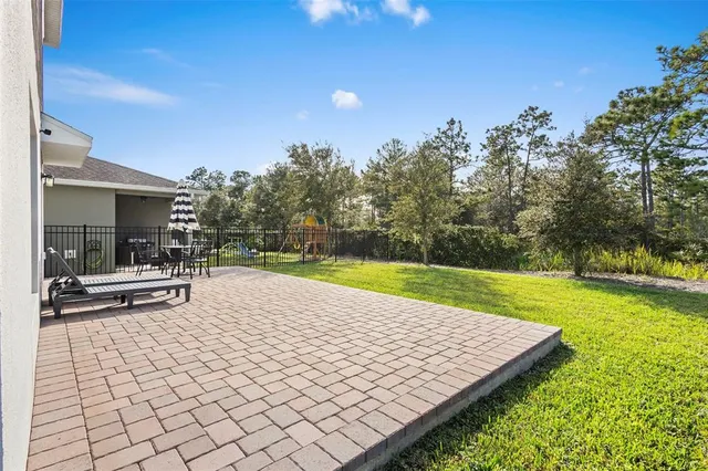an aerial view of a houses with a swimming pool