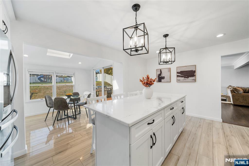 25 Glenview Road Nutley, NJ 07110 - Photo 13 of 49 a kitchen with a dining table chairs sink and cabinets