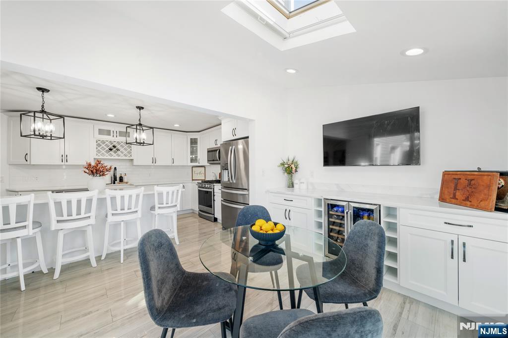 25 Glenview Road Nutley, NJ 07110 - Photo 16 of 49 a living room with furniture a flat screen tv and kitchen view