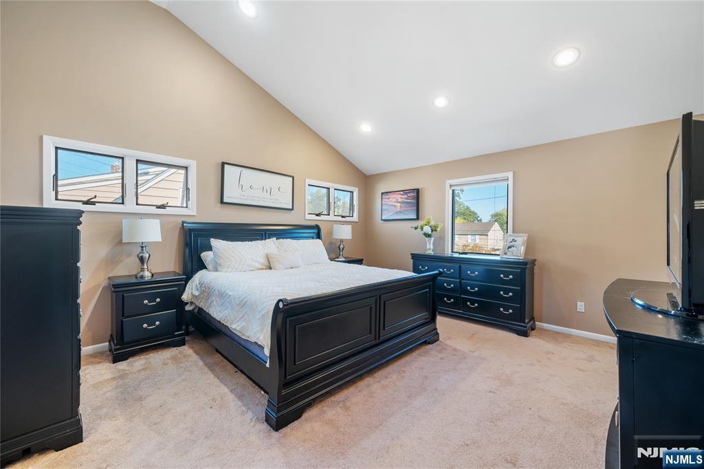 25 Glenview Road Nutley, NJ 07110 - Photo 26 of 49 a spacious bedroom with a bed and a flat screen tv